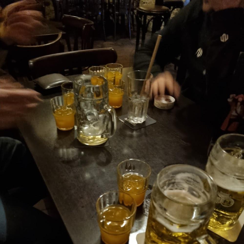 A table with drinks and a beer mug.